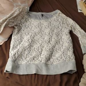 White lace on a gray sweatshirt
